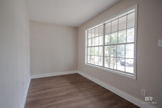 empty room featuring dark hardwood / wood-style flooring