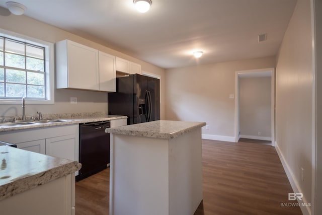 kitchen featuring white cabinetry, dark wood-type flooring, black appliances, and light stone countertops