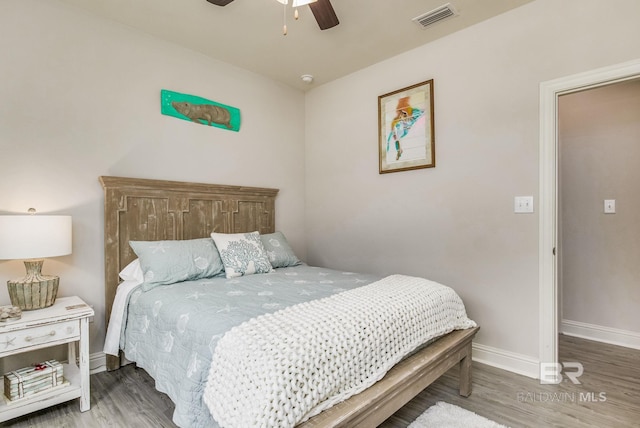 bedroom featuring hardwood / wood-style floors and ceiling fan