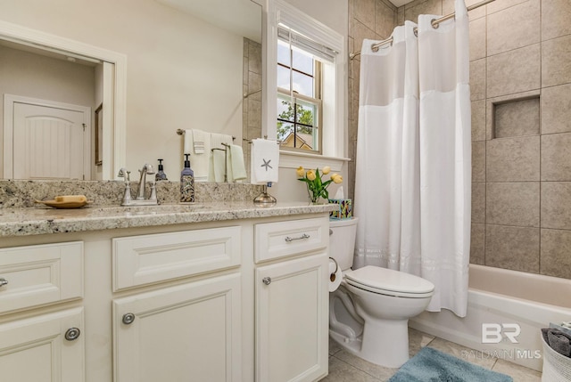 full bathroom featuring tile patterned floors, toilet, vanity, and shower / bath combo