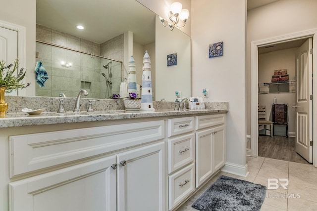 bathroom with tile patterned floors, vanity, and an enclosed shower