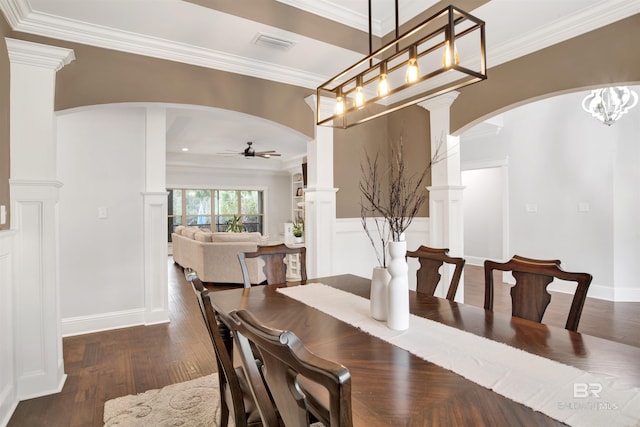 dining room with ornamental molding, dark wood-type flooring, and ceiling fan with notable chandelier