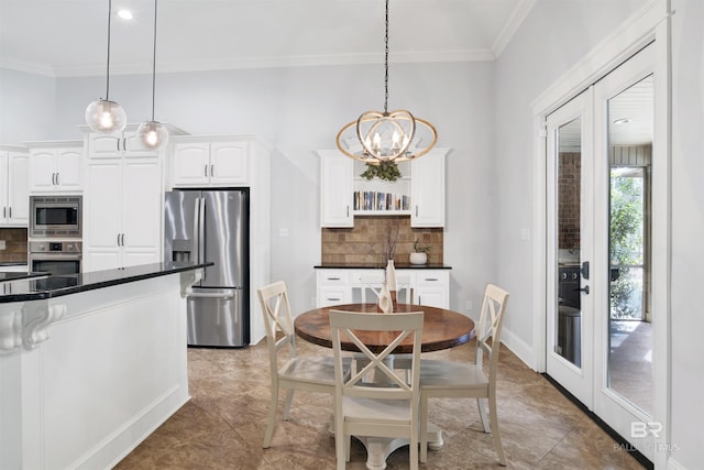 tiled dining room featuring ornamental molding, a chandelier, and french doors