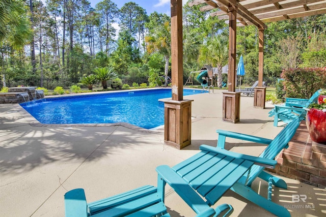 view of pool featuring pool water feature, a pergola, and a patio