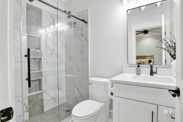 bathroom with vanity, an enclosed shower, ceiling fan, and toilet