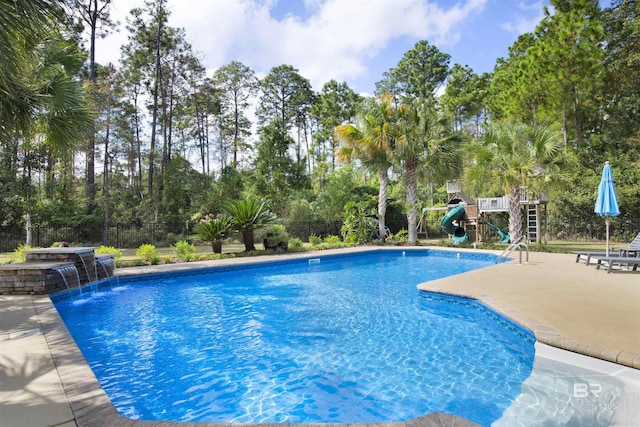 view of swimming pool with pool water feature and a patio area