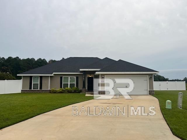 ranch-style home featuring a garage and a front lawn