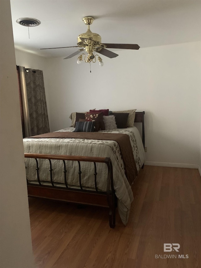 bedroom with dark wood-type flooring and ceiling fan