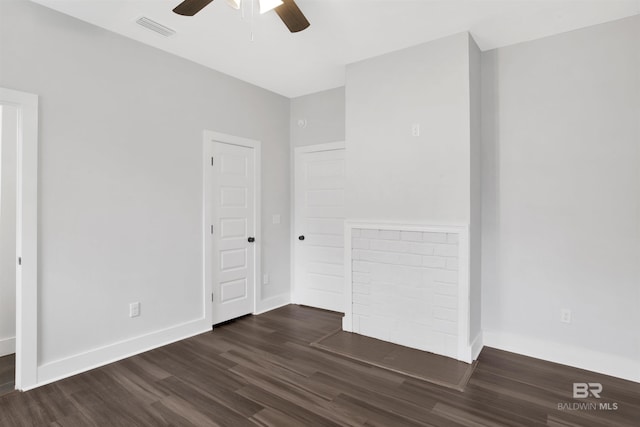 empty room with ceiling fan and dark hardwood / wood-style floors