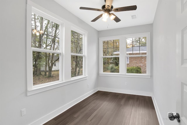 unfurnished sunroom featuring ceiling fan