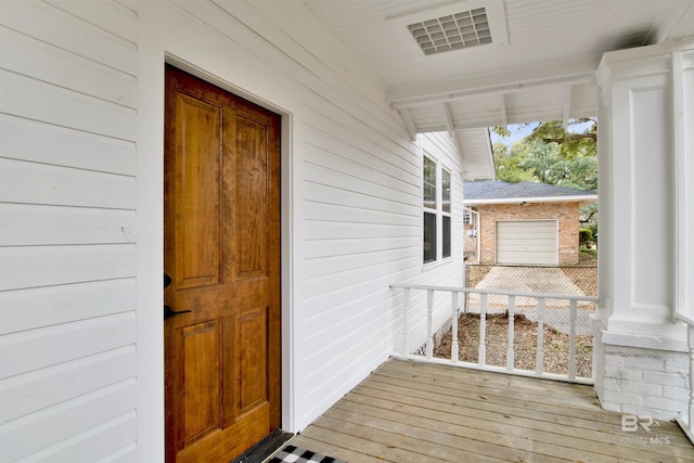 entrance to property featuring a garage and covered porch