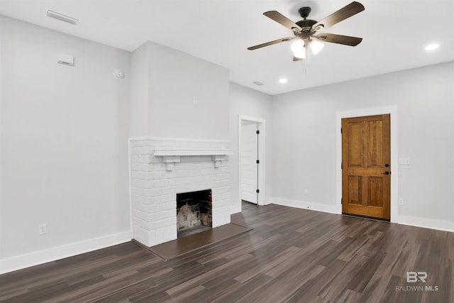 unfurnished living room with ceiling fan, dark hardwood / wood-style floors, and a fireplace