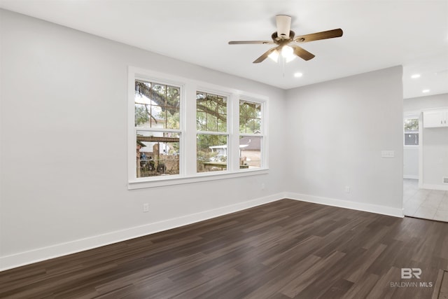 empty room featuring dark hardwood / wood-style floors and ceiling fan