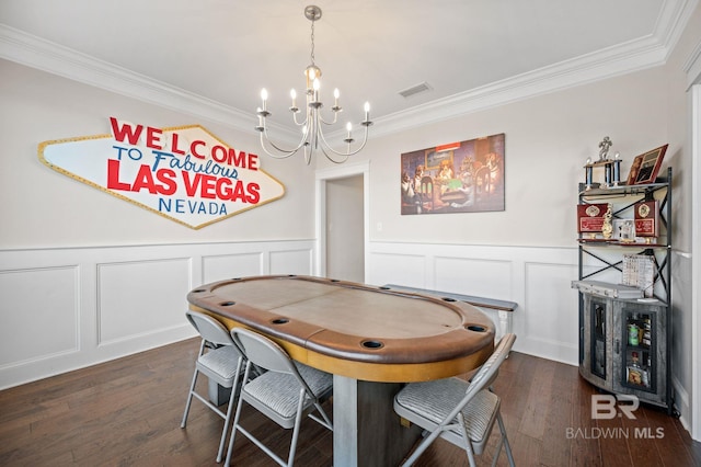 dining space featuring a chandelier, ornamental molding, and dark hardwood / wood-style floors