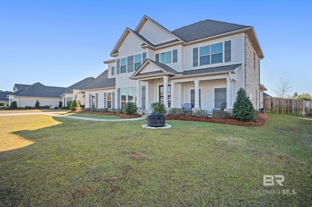 craftsman house featuring a front yard and an outdoor fire pit