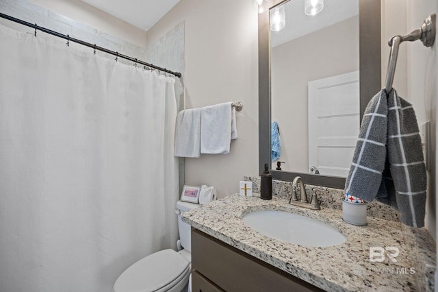 bathroom with toilet and vanity