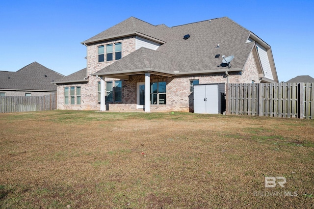 back of house with a yard