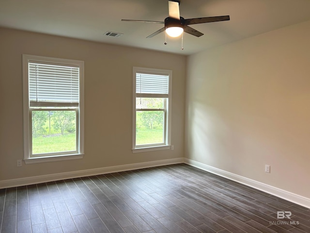 empty room featuring ceiling fan and dark hardwood / wood-style floors