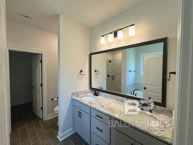 full bathroom with vanity, toilet, and separate shower and tub