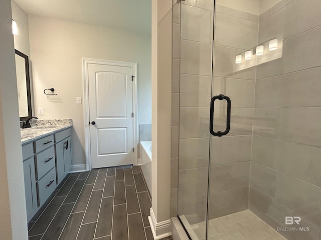 bathroom with vanity and separate shower and tub