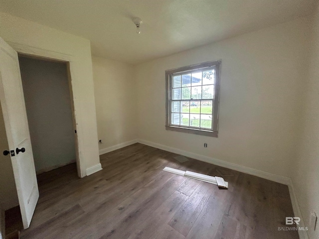 unfurnished bedroom with dark hardwood / wood-style floors