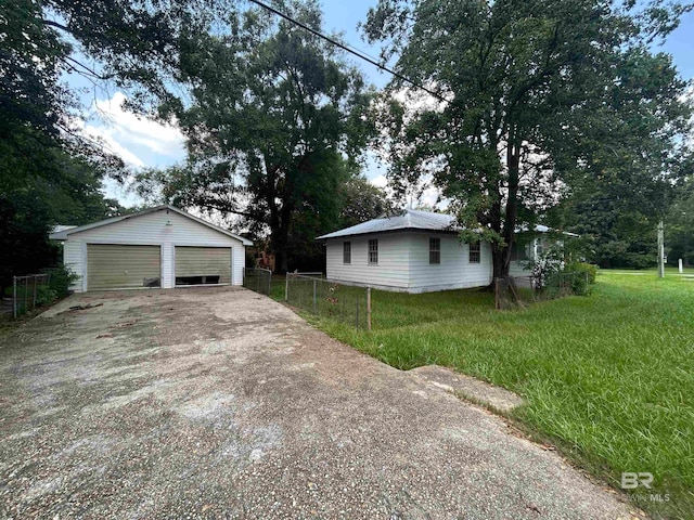 view of property exterior featuring a lawn, a garage, and an outdoor structure