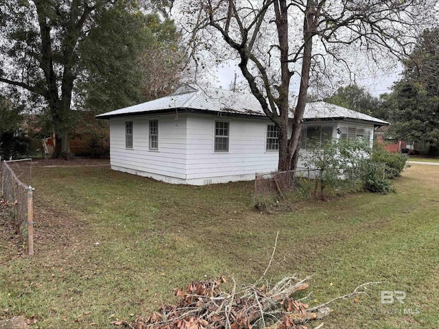 view of side of home featuring a yard