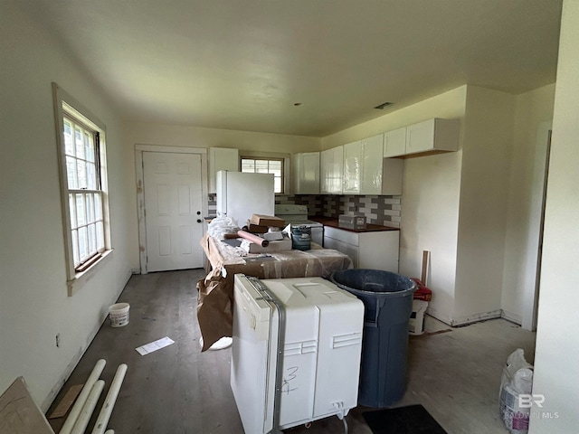 kitchen featuring white cabinetry, white appliances, hardwood / wood-style flooring, and tasteful backsplash