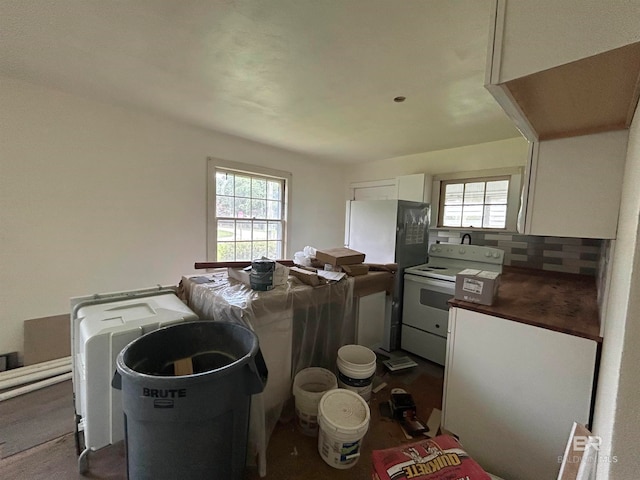 kitchen with white appliances and white cabinets