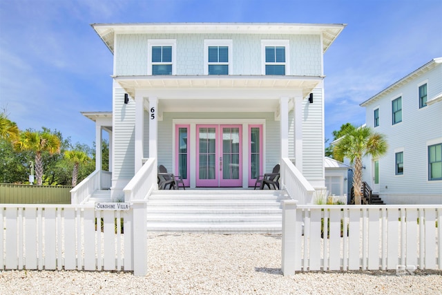 view of front of home with french doors and fence private yard