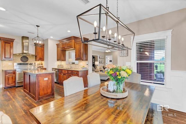 26506 Big Grant Way, Robertsdale, AL 36567 - dining room featuring a chandelier, dark wood-style floors, recessed lighting, and wainscoting