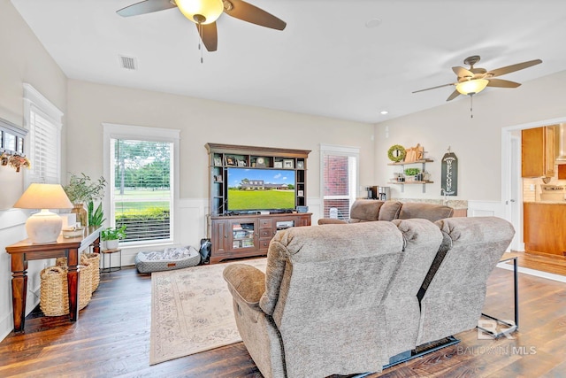 26506 Big Grant Way, Robertsdale, AL 36567 - living room featuring a ceiling fan, wainscoting, and dark wood-type flooring