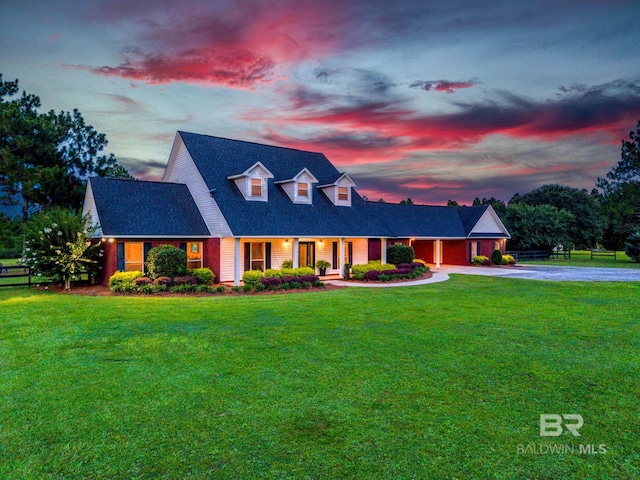 26506 Big Grant Way, Robertsdale, AL 36567 - cape cod-style house with driveway, an attached garage, and covered porch