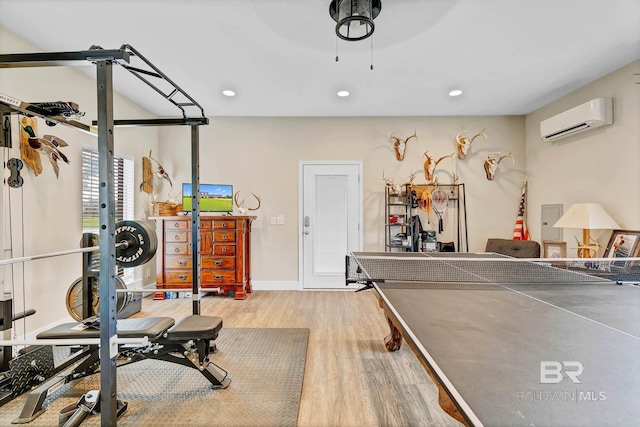 26506 Big Grant Way, Robertsdale, AL 36567 - playroom featuring a wall unit AC, wood finished floors, recessed lighting, and ceiling fan