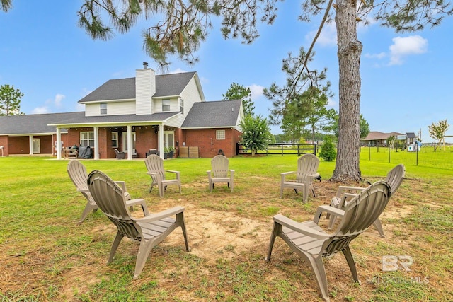 26506 Big Grant Way, Robertsdale, AL 36567 - view of green lawn featuring an outdoor fire pit