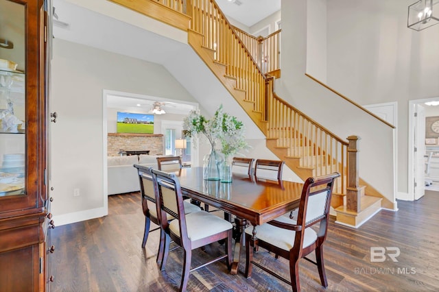 26506 Big Grant Way, Robertsdale, AL 36567 - dining area featuring a towering ceiling, wood finished floors, stairway, a stone fireplace, and ceiling fan