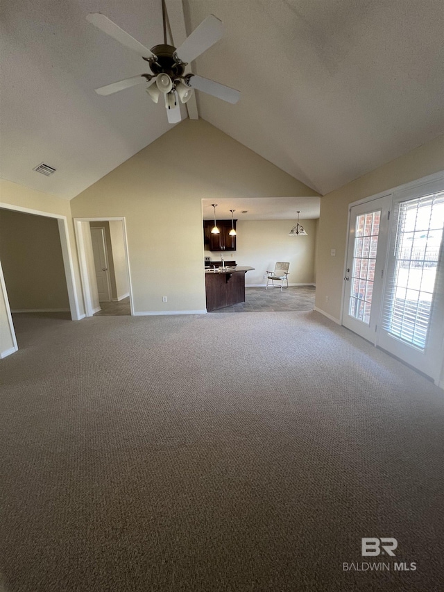 unfurnished living room featuring lofted ceiling, carpet floors, and ceiling fan