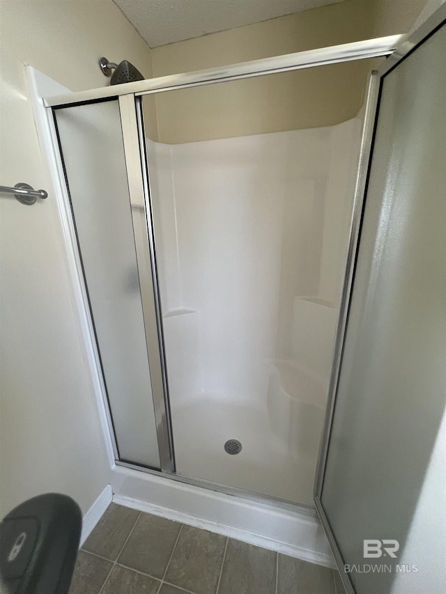 bathroom with a shower with shower door