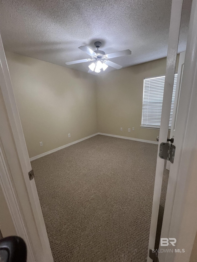 empty room featuring carpet, a textured ceiling, and ceiling fan