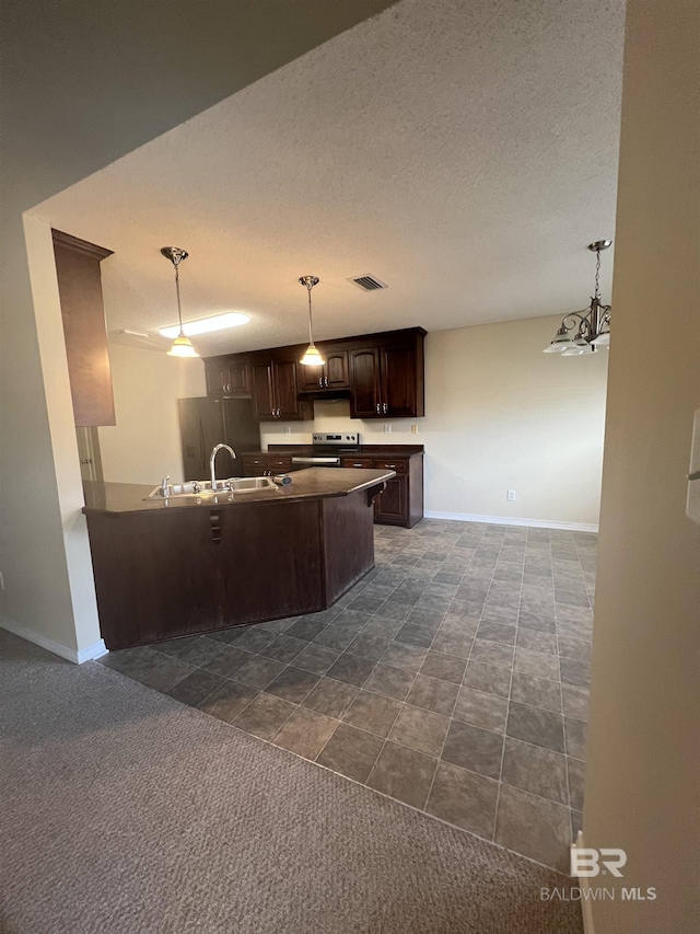 kitchen with sink, stainless steel electric range, dark brown cabinetry, decorative light fixtures, and kitchen peninsula