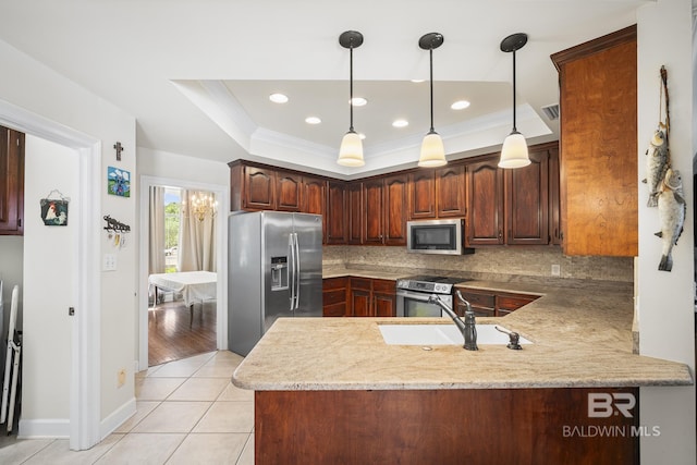 402 Potters Mill Ave, Daphne, AL 36526 - kitchen with stainless steel appliances, a sink, a peninsula, decorative backsplash, and pendant lighting