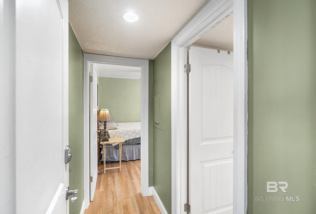 1095 Sea Cliff S Unit 1095, Daphne, AL 36526 - corridor featuring light wood-style flooring, a textured ceiling, and baseboards
