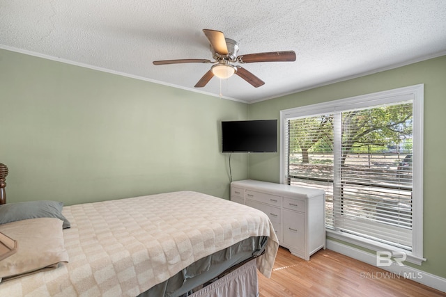 1095 Sea Cliff S Unit 1095, Daphne, AL 36526 - bedroom featuring light wood finished floors, a textured ceiling, crown molding, and ceiling fan