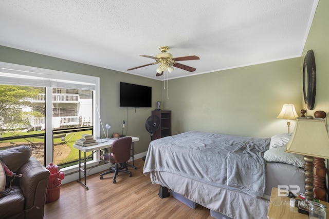1095 Sea Cliff S Unit 1095, Daphne, AL 36526 - bedroom featuring baseboards, a textured ceiling, crown molding, ceiling fan, and wood finished floors