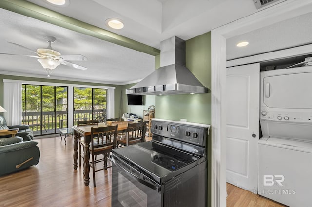 1095 Sea Cliff S Unit 1095, Daphne, AL 36526 - kitchen with ceiling fan, wall chimney range hood, ornamental molding, black electric range, and stacked washer / drying machine