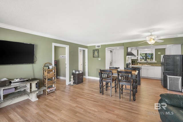 1095 Sea Cliff S Unit 1095, Daphne, AL 36526 - dining space with light wood-style floors, crown molding, ceiling fan, visible vents, and baseboards
