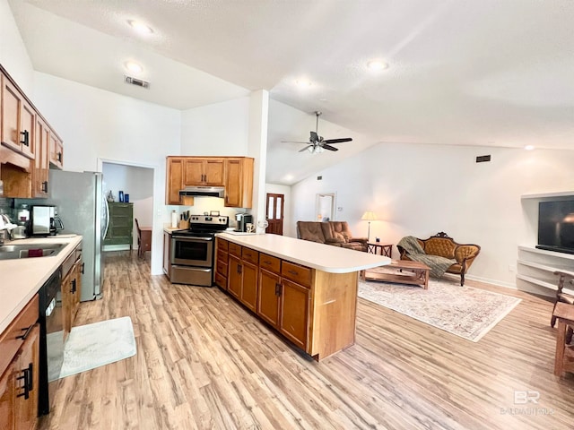 kitchen featuring high vaulted ceiling, sink, ceiling fan, appliances with stainless steel finishes, and light hardwood / wood-style floors