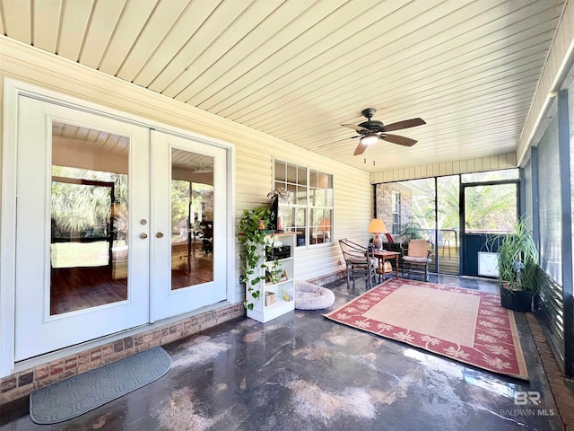 unfurnished sunroom with ceiling fan and french doors