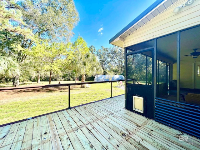 wooden terrace with a sunroom and a yard