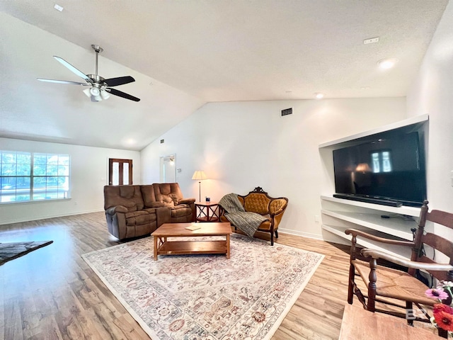 living room featuring hardwood / wood-style flooring, ceiling fan, a textured ceiling, and vaulted ceiling